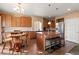 A beautiful kitchen featuring wood cabinets and an island with stool seating at 9626 E 105Th Pl, Commerce City, CO 80640