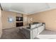 Spacious living room featuring large windows, coffered ceiling, recessed lighting, and plush carpeting at 9626 E 105Th Pl, Commerce City, CO 80640