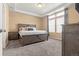 Spacious main bedroom with trey ceiling, an attractive headboard, a large window and soft, neutral carpet at 9626 E 105Th Pl, Commerce City, CO 80640