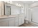 Clean bathroom featuring a large double sink vanity, toilet, and a glass enclosed shower stall at 24780 E 39Th Ave, Aurora, CO 80019