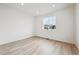 Bright bedroom with neutral colored flooring and a large window offering ample natural light at 24780 E 39Th Ave, Aurora, CO 80019