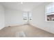 Bright bedroom with neutral carpet, white walls and multiple windows that let in lots of natural light at 24780 E 39Th Ave, Aurora, CO 80019