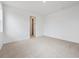 A bright bedroom featuring neutral carpet and a doorway with closet visible at 24780 E 39Th Ave, Aurora, CO 80019