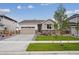 Charming one-story home with a well-manicured lawn, stone accents, and an attached two-car garage at 24780 E 39Th Ave, Aurora, CO 80019