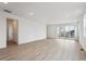 Spacious and bright living room with laminate floors, neutral walls, and a large sliding glass door at 24780 E 39Th Ave, Aurora, CO 80019