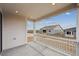 Covered porch featuring white columns, providing a cozy outdoor space with views of the surrounding neighborhood at 24780 E 39Th Ave, Aurora, CO 80019