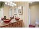 Bathroom with double vessel sinks, granite countertops, and decorative mirrors at 7284 Timbercrest Ln, Castle Pines, CO 80108
