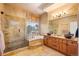 Bathroom featuring a glass shower, soaking tub, double sinks, and stylish tile work at 7284 Timbercrest Ln, Castle Pines, CO 80108