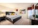 Elegant bedroom with large windows, a dresser, and a comfortable bed at 7284 Timbercrest Ln, Castle Pines, CO 80108