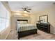 Bright bedroom with a ceiling fan, a shelf, and a large window with blinds at 7284 Timbercrest Ln, Castle Pines, CO 80108