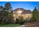 Charming exterior view of the house showcasing the deck and mature landscaping at 7284 Timbercrest Ln, Castle Pines, CO 80108