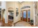 Grand entryway with hardwood floors, a decorative front door, and views into the dining room at 7284 Timbercrest Ln, Castle Pines, CO 80108