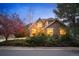 Charming two-story home with lush greenery and a stone-accented facade at 7284 Timbercrest Ln, Castle Pines, CO 80108