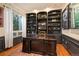Home office with custom built-ins, a large desk, and natural light at 7284 Timbercrest Ln, Castle Pines, CO 80108