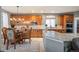 Charming kitchen and breakfast nook area featuring custom cabinetry and stainless steel appliances at 7284 Timbercrest Ln, Castle Pines, CO 80108