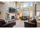 Spacious living room with vaulted ceilings, fireplace, and plenty of natural light at 7284 Timbercrest Ln, Castle Pines, CO 80108