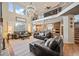 Bright and airy living room with a view of the upper floor and an open connection to the kitchen at 7284 Timbercrest Ln, Castle Pines, CO 80108