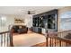 A comfortable loft with a dark grey bookshelf, hardwood floors, and natural light from windows at 7284 Timbercrest Ln, Castle Pines, CO 80108