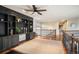 Open loft area with built-in shelving, hardwood floors, and wrought-iron railing at 7284 Timbercrest Ln, Castle Pines, CO 80108