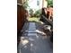 Path through backyard from back patio to deck, with greenery on the side and a wooden fence at 7988 S Johnson Ct, Littleton, CO 80128