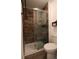 Modern bathroom with a tiled shower, glass door, and minimalist design, offering a clean and functional space at 7988 S Johnson Ct, Littleton, CO 80128