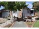 Well-manicured front yard with lush greenery, stone pathway, and charming landscaping details enhancing curb appeal at 7988 S Johnson Ct, Littleton, CO 80128