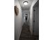 Hallway with hardwood floors and modern decor, offering a clean and organized pathway to various rooms in the house at 7988 S Johnson Ct, Littleton, CO 80128
