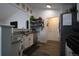 Modern kitchen featuring granite countertops, stainless steel appliances, and open shelving, offering both style and functionality at 7988 S Johnson Ct, Littleton, CO 80128