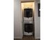 Convenient stacked washer and dryer unit tucked neatly into a closet space, maximizing efficiency at 7988 S Johnson Ct, Littleton, CO 80128