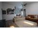 Bright living room featuring hardwood floors, vaulted ceilings, and a seamless flow into the dining area at 7988 S Johnson Ct, Littleton, CO 80128