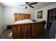 Cozy bedroom with a rustic wood bed frame, soft carpet, and ample natural light, creating a comfortable retreat at 7988 S Johnson Ct, Littleton, CO 80128