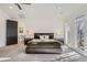 Spacious bedroom with a dark wood platform bed and natural light at 1237 S Saint Paul St, Denver, CO 80210