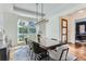 Spacious dining room with large windows, hardwood floors, and a modern chandelier at 1237 S Saint Paul St, Denver, CO 80210