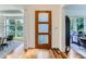 Bright entryway with hardwood floors and a modern wood door at 1237 S Saint Paul St, Denver, CO 80210