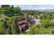 Aerial view of a beautiful home surrounded by lush trees and landscaping at 12212 W 16Th Dr, Lakewood, CO 80215