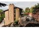 Multi-tiered backyard with multiple patio areas for entertaining with lush green hillside and mature trees at 12212 W 16Th Dr, Lakewood, CO 80215