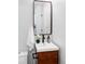 Modern bathroom featuring a white vanity with dark fixtures, a decorative vase, and fresh white towels at 12212 W 16Th Dr, Lakewood, CO 80215