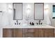Modern bathroom with double vanity, dark hardware, and twin mirrors at 12212 W 16Th Dr, Lakewood, CO 80215
