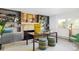 Bright home office with a fireplace and bookshelves, styled with vibrant decor and a large desk at 12212 W 16Th Dr, Lakewood, CO 80215
