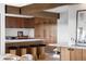 Modern kitchen with wood cabinets, breakfast bar with stools, and stainless steel appliances at 12212 W 16Th Dr, Lakewood, CO 80215