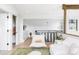 Bright, open living room with hardwood floors, modern white furniture, and an open staircase at 12212 W 16Th Dr, Lakewood, CO 80215