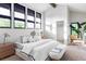 Bright main bedroom featuring large windows, modern decor, and a comfortable king-size bed at 12212 W 16Th Dr, Lakewood, CO 80215
