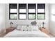 Bright main bedroom features large windows, modern decor, and side tables with lamps at 12212 W 16Th Dr, Lakewood, CO 80215