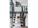 Modern staircase with light wood treads and a black railing at 12212 W 16Th Dr, Lakewood, CO 80215