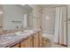 Bright bathroom featuring a shower-tub combo, patterned countertop, and neutral wall color at 2880 Lake Meadow Dr, Monument, CO 80132