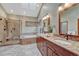 Bright bathroom featuring double vanity sinks, soaking tub, and a glass shower at 2880 Lake Meadow Dr, Monument, CO 80132