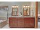 Elegant bathroom with double vanity, granite countertops, and custom wood cabinetry at 2880 Lake Meadow Dr, Monument, CO 80132