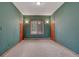 An empty bedroom with carpet floors, green walls, and wood trim around the doors and window at 2880 Lake Meadow Dr, Monument, CO 80132