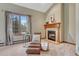 Relaxing bedroom featuring a large window, fireplace and carpeted floors at 2880 Lake Meadow Dr, Monument, CO 80132