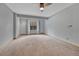 Bright bedroom with a ceiling fan, gray walls, and cozy carpet, offering a serene living space at 2880 Lake Meadow Dr, Monument, CO 80132